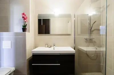 a bathroom with a sink and a toilet and a mirror at T2 PORTICCIO AGOSTA PLAGE 100M DE LA PLAGE in Porticcio