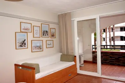 a room with a bed and a sliding glass door at Evasion Corse Direct mer Piscine Terrasse in Moriani Plage