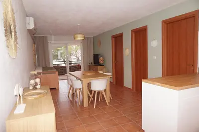 a kitchen and dining room with a table and chairs at Evasion Corse Direct mer Piscine Terrasse in Moriani Plage