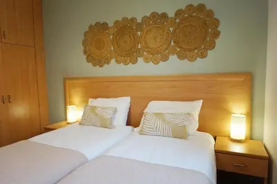 two beds in a hotel room with two lamps at Evasion Corse Direct mer Piscine Terrasse in Moriani Plage