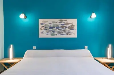 a blue room with a bed and a blue wall at Appartement a Baracci in Olmeto
