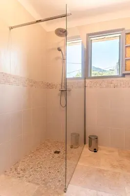 a bathroom with a shower with a glass door at Appartement a Baracci in Olmeto