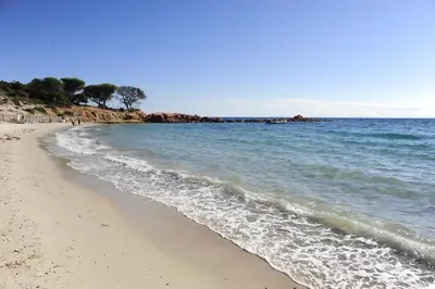 a sandy beach with the ocean in the background at Appartement a Baracci in Olmeto