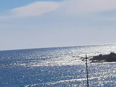 a view of the ocean with a cross at JACUZZI AJACCIO ENTRE MER ET MONTAGNE 200m DES PLUS BELLES PLAGES in Ajaccio