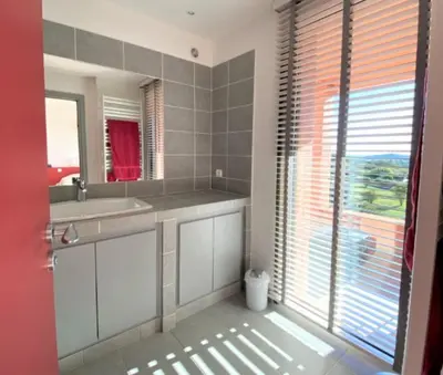a bathroom with a sink and a mirror at Villa La Tour de Pinarello in Mangialla