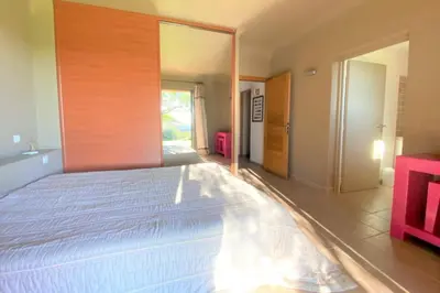 a bedroom with a large white bed in a room at Villa La Tour de Pinarello in Mangialla