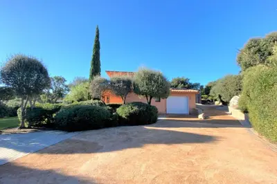 a house with a driveway with trees and a garage at Villa La Tour de Pinarello in Mangialla