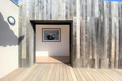 a doorway into a room with a wooden wall at Villa La Tour de Pinarello in Mangialla