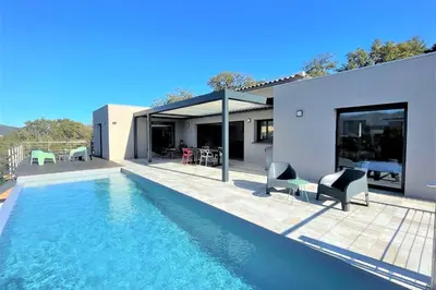 a house with a swimming pool in front of a house at Villa Montinu Di Caramontinu in Sainte-Lucie de Porto-Vecchio