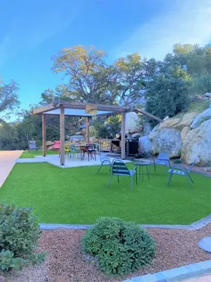 a gazebo with chairs and tables on the grass at Villa Montinu Di Caramontinu in Sainte-Lucie de Porto-Vecchio