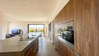 a kitchen with wooden cabinets and a counter top at Villa Caramontinu in Sainte-Lucie de Porto-Vecchio