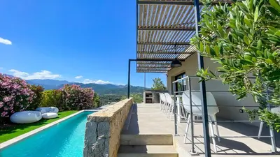 a house with a swimming pool next to a building at Villa Caramontinu in Sainte-Lucie de Porto-Vecchio