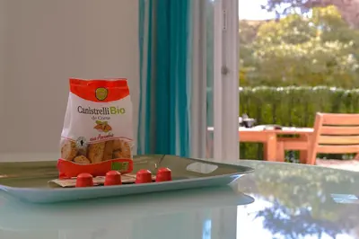 a plate with a bag of crisps on a table at Appartement refait à neuf, proche plage et centre ville- Ajaccio-Parc Berthaut in Ajaccio