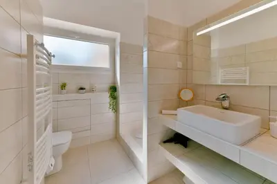 a white bathroom with a sink and a toilet at Appartement refait à neuf, proche plage et centre ville- Ajaccio-Parc Berthaut in Ajaccio