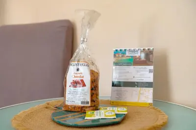 a bottle of bread sitting on a table next to a box at Studio rénové Hyper Centre- Ajaccio in Ajaccio