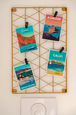 a rack with posters hanging on a wall at Studio rénové Hyper Centre- Ajaccio in Ajaccio