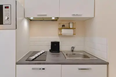 a small kitchen with a sink and a counter at Studio rénové Hyper Centre- Ajaccio in Ajaccio