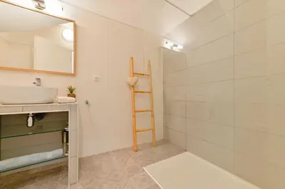 a bathroom with a sink and a mirror at Charmant Appartement - Jardinet Privé - 5 minutes des plages Sanguinaires - Ajaccio in Ajaccio