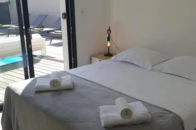 a bedroom with a bed with towels on it at Villa Rossa 6 pers dans résidence avec piscine chauffée privée in Lecci