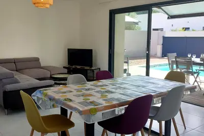 a living room with a table and chairs at Villa Rossa 6 pers dans résidence avec piscine chauffée privée in Lecci