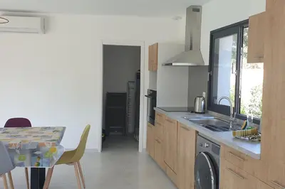 a kitchen with a sink and a table with a dining room at Villa Rossa 6 pers dans résidence avec piscine chauffée privée in Lecci