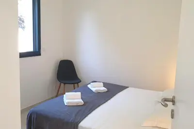 a bedroom with a bed with two towels on it at Villa Rossa 6 pers dans résidence avec piscine chauffée privée in Lecci
