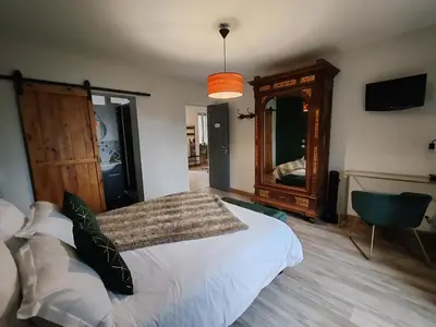 a bedroom with a bed and a large mirror at Chambre d'hôtes casa di l'apa in Venaco