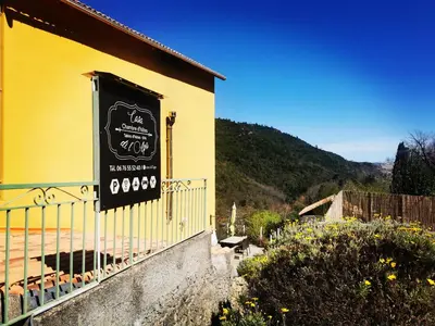 a building with a sign on the side of it at Chambre d'hôtes casa di l'apa in Venaco