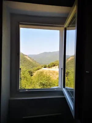 a window with a view of a mountain view at Maison de village avec jardin privatif in Zicavo