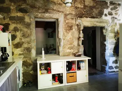 a kitchen with a white cabinet in a room at Maison de village avec jardin privatif in Zicavo