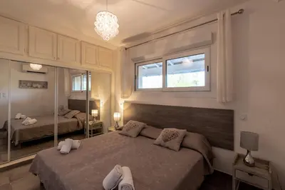 a bedroom with two beds and a large mirror at Les Arcades de Cala Rossa in Lecci