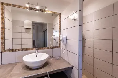 a bathroom with a sink and a mirror at Les Arcades de Cala Rossa in Lecci
