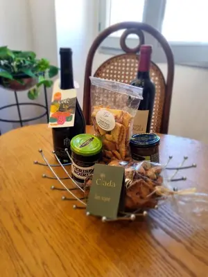 a basket of food and wine on a table at Appartement CLADA/ Côté Lac in Ajaccio