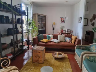 a living room with a couch and a table at Appartement CLADA/ Côté Lac in Ajaccio