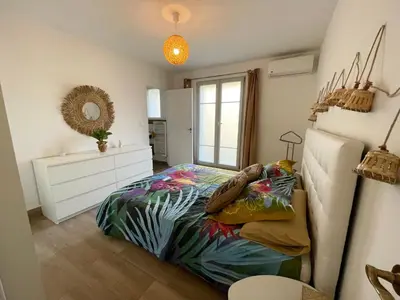 a bedroom with a bed and a dresser and a window at Les jardins de Funtanone in Vignale