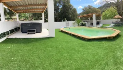 a backyard with a swimming pool and green grass at Les jardins de Funtanone in Vignale