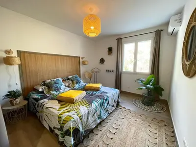 a bedroom with a bed and a window at Les jardins de Funtanone in Vignale