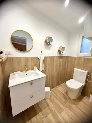a bathroom with a sink and a toilet and a mirror at Les jardins de Funtanone in Vignale