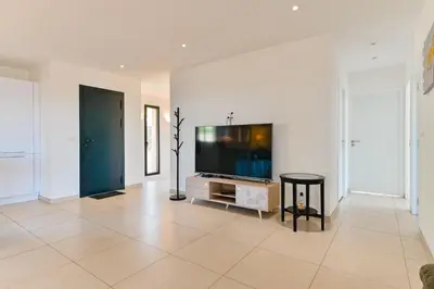a living room with a flat screen tv on a wall at Villa Terrasse et Piscine à l'entrée de Porticcio in Cauro
