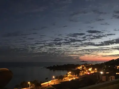 a view of a body of water at night at Superbe appartement T2 Vue magnifique Sanguinaires à 50m de la plage in Ajaccio