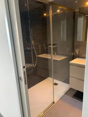 a bathroom with a glass shower and a sink at Superbe appartement T2 Vue magnifique Sanguinaires à 50m de la plage in Ajaccio