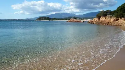 a beach with the sand and the water at Camping l'Oso in Porto-Vecchio