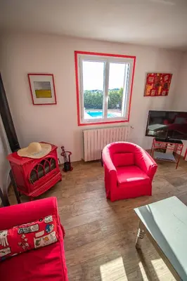 a living room with red chairs and a red couch at U Paradisu - Villa 10/12 pers avec piscine privée in Alata