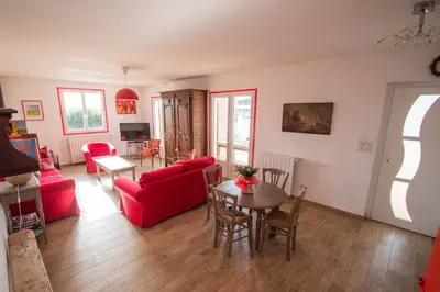 a living room with a red couch and a table at U Paradisu - Villa 10/12 pers avec piscine privée in Alata