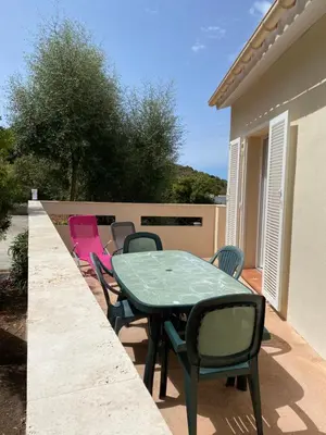 a green table and chairs on a patio at Casa Lova in Propriano
