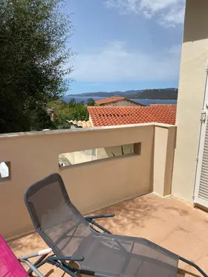 a chair sitting on a patio in front of a building at Casa Lova in Propriano