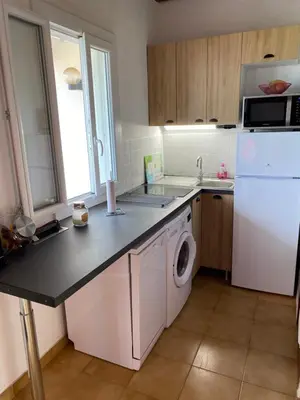 a kitchen with a white refrigerator and a dishwasher at Casa Lova in Propriano
