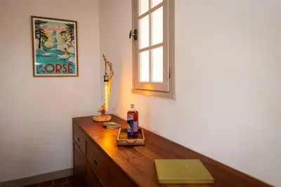 a wooden dresser in a room with a window at Villa à Conca avec piscine pour 8 personnes en Corse du Sud in Conca