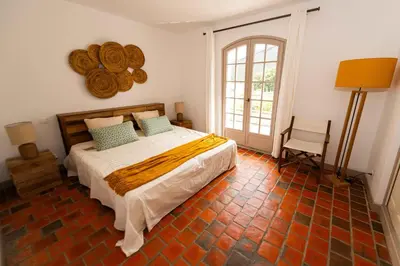 a bedroom with a bed and a large window at Villa à Conca avec piscine pour 8 personnes en Corse du Sud in Conca