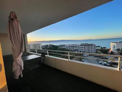a room with a balcony with a view of the ocean at Bagnu di sole - sur la route des îles sanguinaires adorable T2 vue mer in Ajaccio